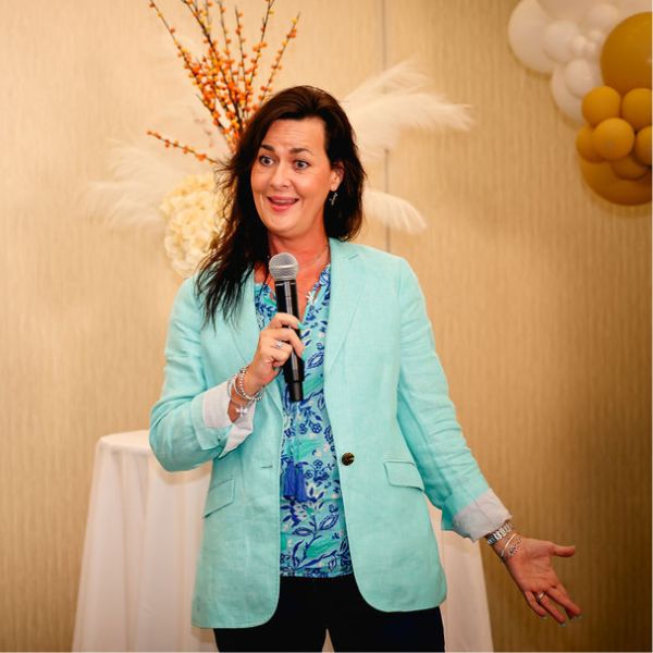Beth Jones Corporate Speaker with microphone